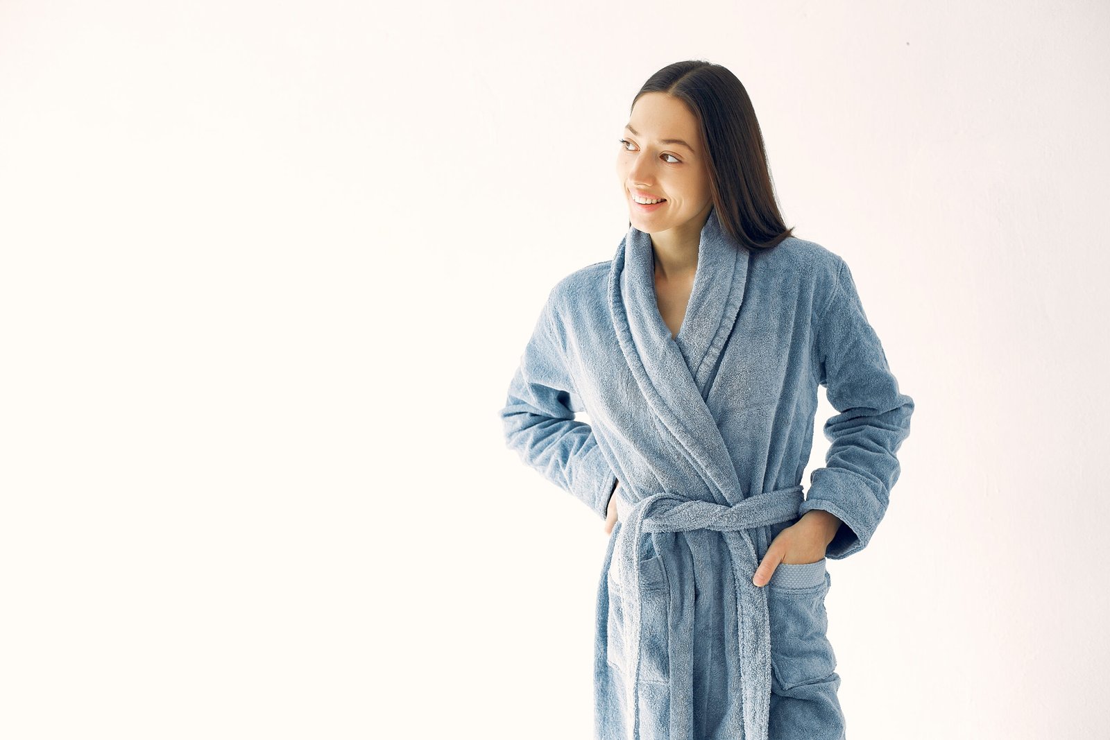 Girl in a studio. Lady in a blue bathrobe.