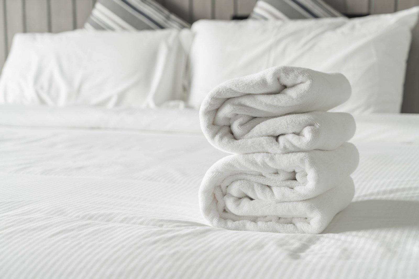 White towel on bed decoration in bedroom interior - Vintage light Filter